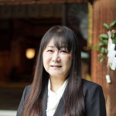 優しい笑顔でこちらを見つめる占い師